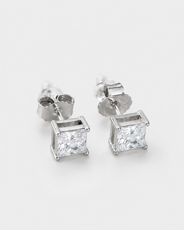 A pair of silver stud earrings featuring square princess-cut clear gemstones in a four-prong setting, shown on a clean white background.